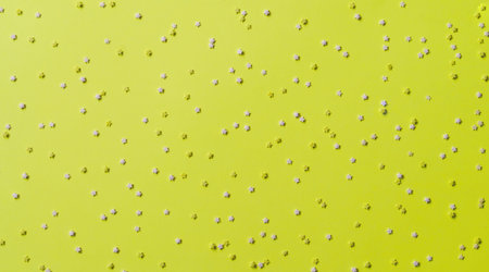 Festive frame made of colorful pastel sprinkles on a yellow background, copy space. Sprinkle sugar...