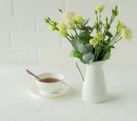 Bouquet of beautiful eustoma flowers on table in dining room. Interior design. Coffee break.の写真素材