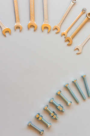 New wrenches on gray background, top view with space for text. professional plumber tools with...