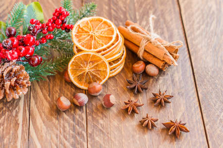 Slices of dried orange with spices for cooking or baking on old rustic wooden background, healthy food.の写真素材