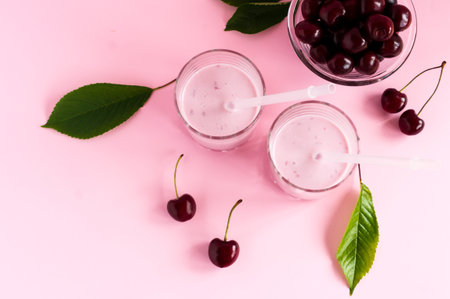 morning cherry smoothie. delicious diet healthy breakfast. pink background. top viewの写真素材