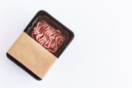 minced pork meat in vacuum plastic packaging on a white background. top view. layout design