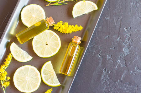 two glass bottles closed with cork kryzhka with essential citrus oil. the concept of well-being and in medical purposesの写真素材