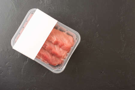 fresh beef steaks in vacuum packaging on a black background. top view. logo layout designの写真素材