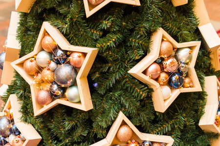 New Year's or Christmas tree is decorated in a modern style. large wooden boxes in the shape of...