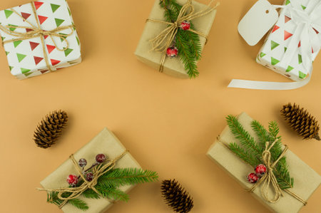 Christmas background with decorations and handmade gifts on beige background with copy space, top...