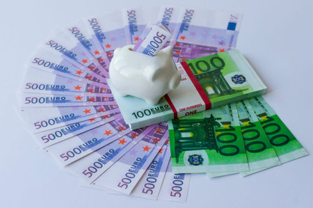 many euro and dollar bills are laid out on a purple background with a package of 100 euros and a...