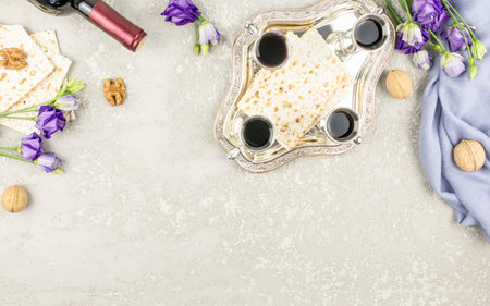 the concept of celebrating Passover. Jewish holiday Passover.matzah, silver glasses with wine on a...