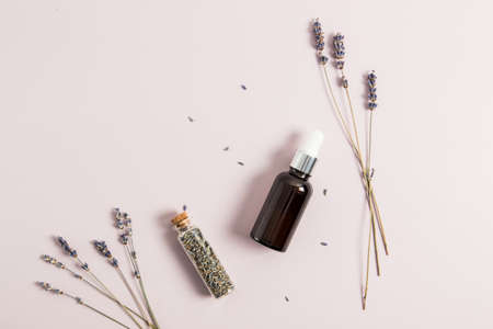 dropper bottle with lavender oil, sprigs of lavender on a pastel background. top view. minimali. space for copyingの写真素材