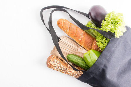 top view of a dark cloth bag filled with organic products . the concept of the right choice of...