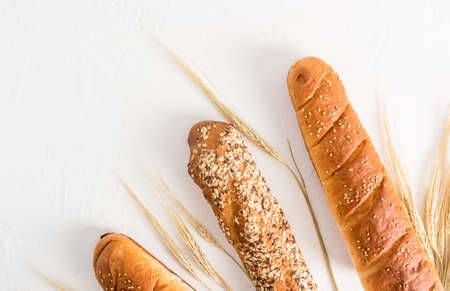 fresh crispy baguette with various useful seeds on a white background with cereals. top view. white background.の写真素材