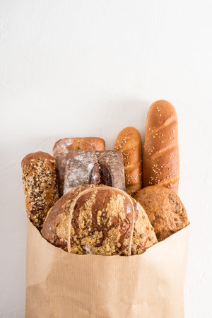a full bag of freshly baked bread in a bakery on a white background. Concept of zero waste, eco...