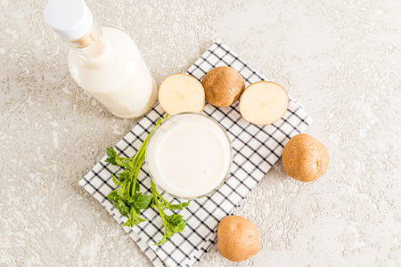 top view of a full glass of potato milk. an alternative to non-milk. vegetable vegan milk. vegetarian foodの写真素材