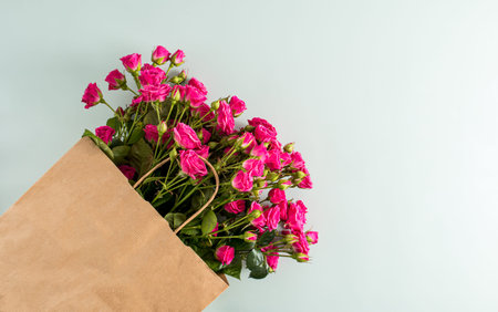Top view of the large crafting package with roses for greetings on a blue background with a copy of the spaceの写真素材