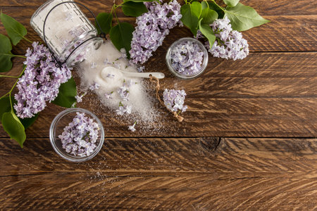 top view of the wooden rustic table with sugar from lilac petals, lilac branches. a copy of the spaceの写真素材