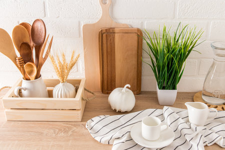 a fragment of the interior of a modern kitchen. various kitchen utensils on a countertop with a houseplant. eco subjectsの写真素材