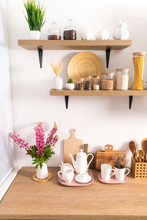 part of the interior of the modern kitchen. open shelves with various jars and countertop with kitchen utensils. ecologically clean kitchenの写真素材