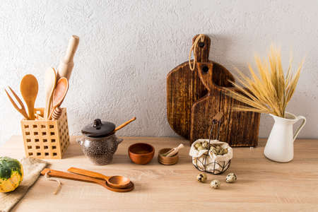 a set of various kitchen utensils of a country house, a cottage on a wooden countertop. interior items. ecologically clean kitchenの写真素材