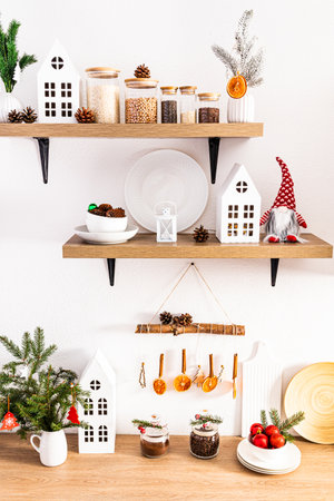 decorating a home kitchen for the new year decorated with crafts with their own hands. cardboard houses, garlands of dried oranges and cinnamonの写真素材