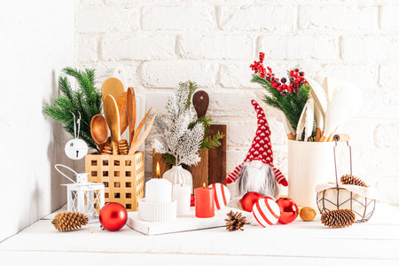 a fragment of a white wooden kitchen countertop with various kitchen items and Christmas decorations in a modern style, made with their own handsの写真素材