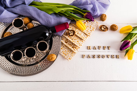 round silver tray with glasses of red wine, matzah, walnuts, a bottle of wine. flat layout. the concept of the Jewish Passover holiday.の写真素材