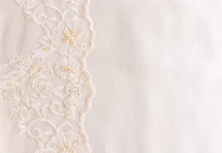 beige satin fabric with lace border and bisser embroidery. wedding background. Template for invitations, books, postcards, greetings. space for text.の写真素材