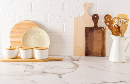 eco-friendly kitchen items on the kitchen countertop against the white brick wall. the concept of a cozy house without wasteの写真素材