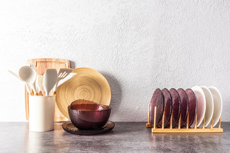 kitchen utensils, tools utensils on a stone countertop against the background of a gray cement wall. interior, modern kitchen spaceの写真素材