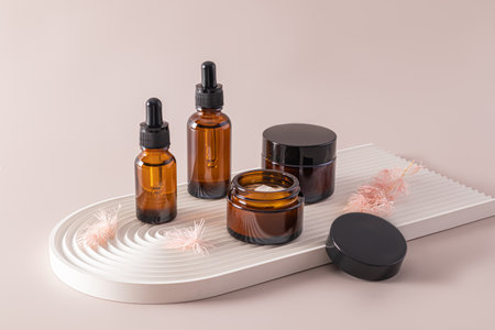 Fece serum in dropper bottle, essential oil, essence or lotion and face cream jar collection. beauty cosmetic skincare. trendy concrete podiumの写真素材