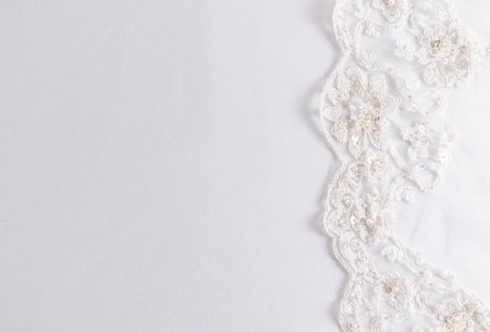 delicate pastel satin background with chic lace on the right side. border. layout for design. wedding invitation, photo album. a place for your textの写真素材