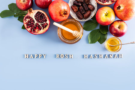 festive background for Rosh Hashanah. A set of traditional food on a blue background with and wooden...