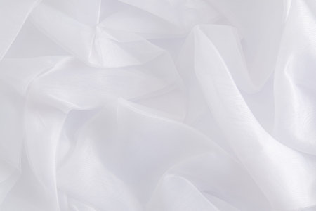 delicate folds of the bride's white silk dress. Beautiful fabric white background. layout for design. A copy of the spaceの写真素材