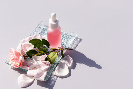 Beautiful matte cosmetic bottle with pipette with organic product, rose oil or serum for personal care. pastel background. A copyspace.の写真素材