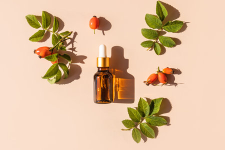 Cosmetic bottle with a pipette with a natural remedy or serum based on rosehip oil for facial and hair skin care. Organic careの写真素材