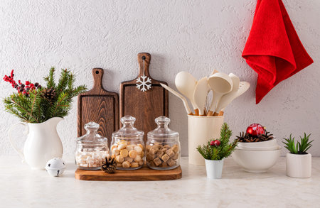 Stylish kitchen Christmas background with kitchen utensils with elements of Christmas decor in...