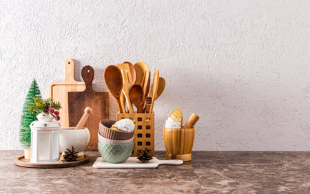 A set of kitchen utensils made of eco-friendly materials on a kitchen stone countertop with...
