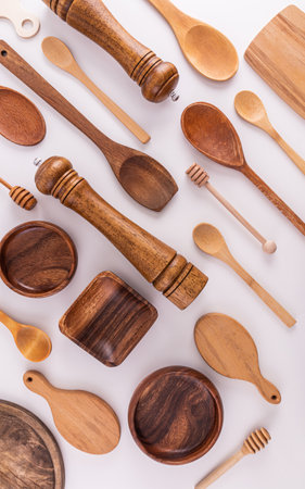 Various kinds of kitchen utensils made of wood eco-friendly materials on a white background. Flat parallel laying. Vertical view. cover. layoutの写真素材