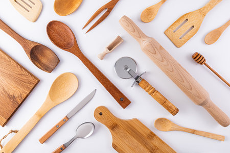 Kitchen wooden utensils, cooking tools on white background. Flat parallel diagonal layout. Kitchen beautiful background. cover. layoutの写真素材
