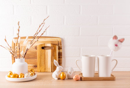 Kitchen festive background for Easter holiday. Easter golden eggs, ceramic bunnies, kitchen utensils...