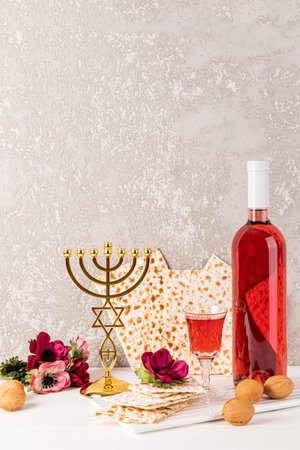 Festive composition for the Jewish Passover. A bottle of kosher wine, matzoth, a crystal glass of...