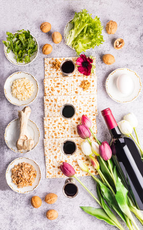 Flat layout of traditional products for the Jewish Passover holiday. Wine, matzoth bread, parsley,...