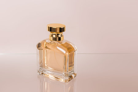 A crystal bottle of women's perfume on a glass surface. An empty presentation bottle. Advertising...