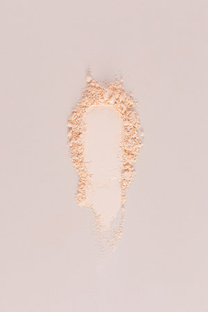A beautiful swatch of natural loose powder for cosmetic facial skin care. Beige vertical background. A copy space. Blank layout. mockup.の写真素材