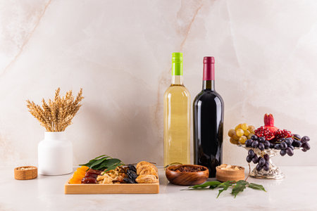 Traditional treats and wine for the Tu bi shvat holiday on the kitchen marble countertop. A green tree as a symbol of the Tu bi shvat holidayの写真素材