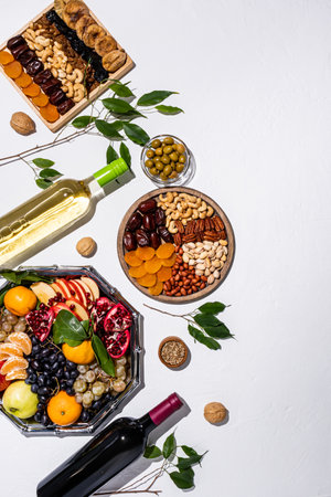 A chic vertical festive background with a set of various treats and traditional holiday symbols. white background. top view. flat lay. A copy spaceの写真素材