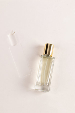 An elegant bottle of cosmetic spray, perfume lies on the light sea sand, a bottle print. top view. A blank bottle mockup. A copy space. Presentation.の写真素材