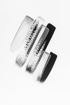 Beautiful parallel brush strokes with acrylic or watercolor paint in black and silver on a white background. abstract artistic background. vertical.の写真素材
