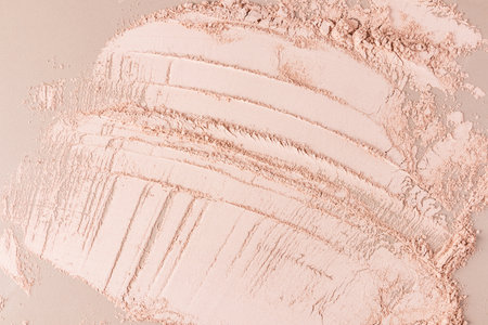 Beautiful brushstroke lines of dry crumbly cosmetic texture in a light tone as a background. a layout, a sample for advertising a cosmetic product.の写真素材