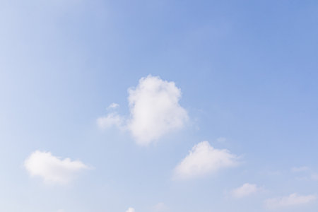 light white clouds in the blue summer sky. Beautiful sky background. A copy of the space. Realistic photo. minimalism.の写真素材