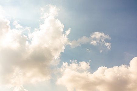 Blue sky with white fluffy clouds. Beautiful landscape background. The concept of nature, atmosphere.の写真素材